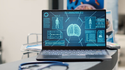 Fototapeta premium Empty reception with brain on display showing neural system disease on laptop at hospital front desk. Neuroscience and tomography medical diagnosis in clinical facility. Close up.