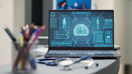 Empty counter with brain x ray scan in medical facility lobby, laptop placed on registration front...