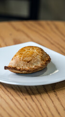 Isolated argentinian empanada in cafeteria