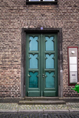 Green beautiful door in Cologne, Germany . External wooden glass door. High quality photo