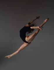 Leg-split jump. Flexible woman. Fit girl stretching and dancing. Stretching sexy flexible body. Flexible woman gymnast. Inspiration. Graceful ballet dancer. Art, motion, flexibility concept.