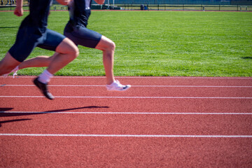 Obraz premium Two youthful racers sprinting on an athletic track