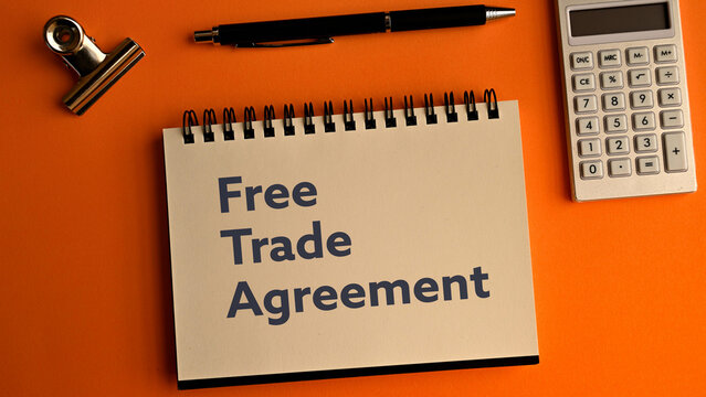 There is notebook with the word Free Trade Agreement. It is as an eye-catching image.