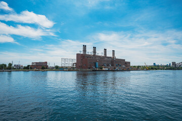 Naklejka premium Factory building with smoke stacks by the east river, New York City, NY.