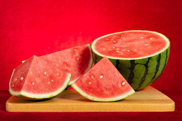 cut out fresh watermelon on red at horizontal composition