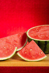 cut out fresh watermelon on red at vertical composition