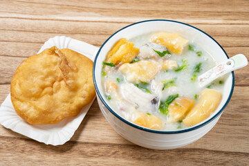 angle view fish porridge with deep-fried Chinese donuts at horizontal composition