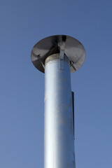 Metal chimney pipe on the roof of house