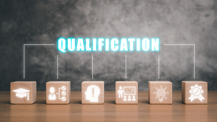 Qualification concept, Wooden block on desk with qualification icon on virtual screen.