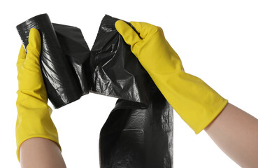 Janitor in rubber gloves ripping off black garbage bag from roll on white background, closeup