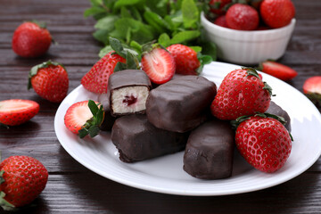 Delicious glazed curds, mint leaves and fresh strawberries on wooden table