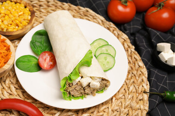 Delicious tortilla wrap with tuna on wicker mat