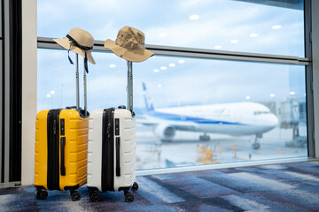 Two suitcases in empty airport hall, traveller cases in departure airport terminal waiting area, vacation concept, blank space for text message or design