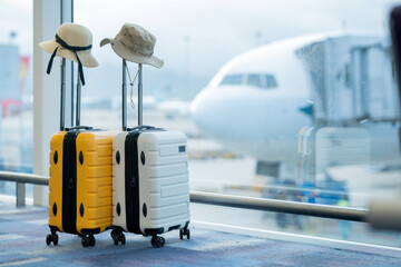 Two suitcases in empty airport hall, traveller cases in departure airport terminal waiting area,...