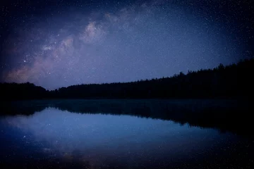 Vlies Fototapete Reflection Amazing starry sky and trees reflecting in lake at night