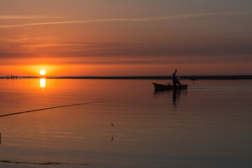 Fishing rod spinning, Fishing rod in rod holder and boat due the fishery day at the sunset. Rod rings. Fishing tackle. Fishing spinning reel, carp fishing. Angler, at sunse, Algeria in Africa.
