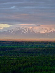 Snow and cloud covered Mount Logan part of the Wrangell-St. Elias Mountain range in Alaska at sunset near Glenallen Alaska