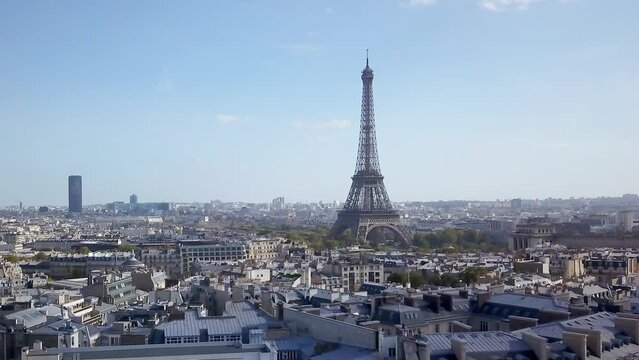 Aerial cinematic drone Paris France Eiffel Tower famous historic landmark from a distance mid day late summer romantic blue sky surrounded by buildings slowly upward motion