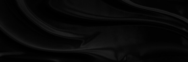 Black gray satin dark fabric texture luxurious shiny that is abstract silk cloth panorama background with patterns soft waves blur beautiful.