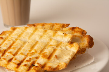 Toasted bread with melted butter, Brazilian breakfast food, Coffee and Milk
