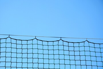 The top of the fence mesh hanging on a wire