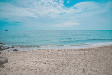 Fototapeta na wymiar Sunny summer beach ocean waves with bubbles and sand background