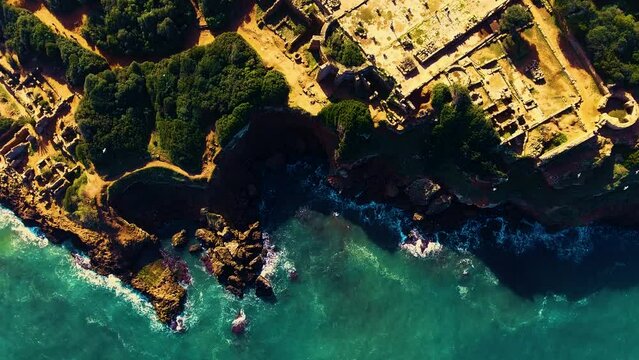 drone shot of the Roman archaeological site of tipaza overlooking the sea