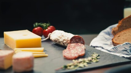 Close packshot of a garden table showcasing a delectable spread of different delicious cheese, salami and bread. For commercials, food vlogs, or summer-themed promotions that celebrate outdoor dining