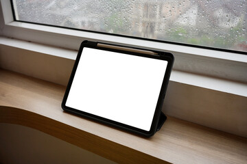 Tablet on wood table space and workspace platform background. Blank screen tablet for advertising concept.