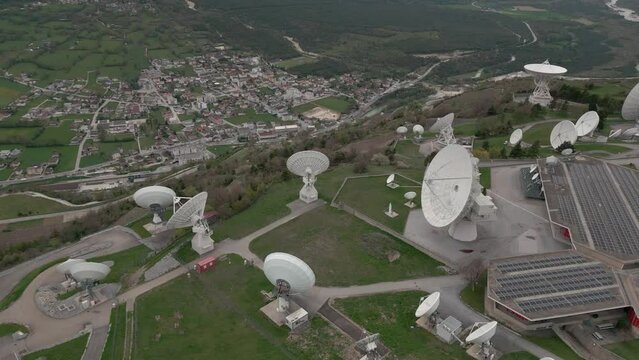 Aerial Shot satellite radio station in Leuk. Huge parabolic antennas with satellite reception. Solar panels on the roof