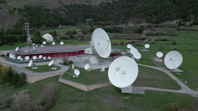 Satellite radio station in Leuk. Large parabolic antennas with solar panels. Aerial Shot