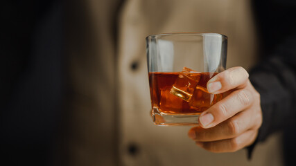 Bartender serving whiskey on wooden bar ,Close-up shot of whiskey glass