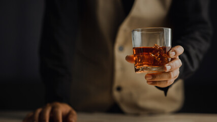 Bartender serving whiskey on wooden bar ,Close-up shot of whiskey glass