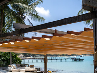 Outdoor retractable roof on wood and iron construction on the beach front restaurant near the...