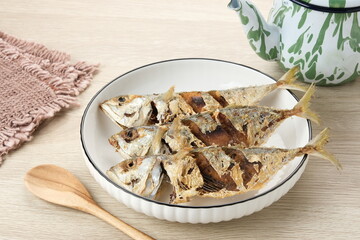 Ikan Kembung Goreng or Fried Mackerel fish, served in white plate
