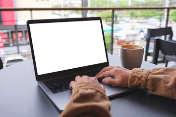 Mockup image of a woman using and working on laptop computer with blank white desktop screen