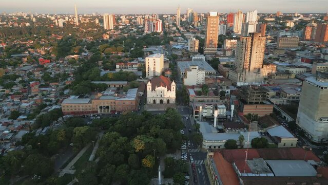 Aerial view of Catedral Metropolitana de Asunci&oacute;n church with downtown skyscrapers of capital of Asuncion city at sunset, Paraguay