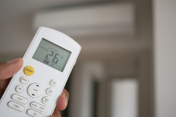 Close up of man hand holding air condition remote.
