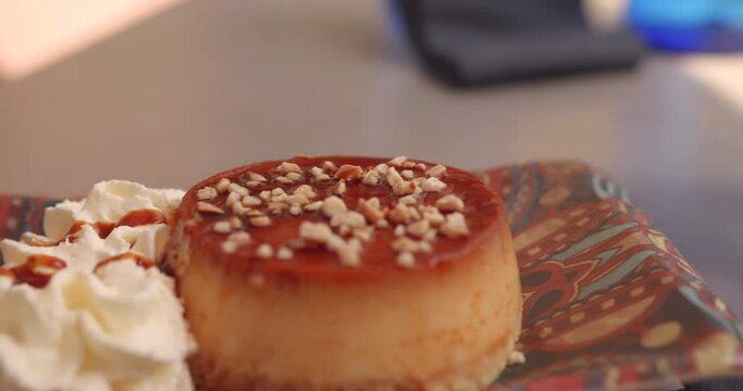 Creme Caramel Flan Topped With Crushed Almonds. - close up