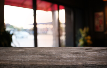 Empty dark wooden table in front of abstract blurred bokeh background of restaurant . can be used for display or montage your products.Mock up for space.