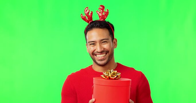 Christmas Gift, Man Portrait And Green Screen With Holiday Party Hat And Happiness With Laugh. Isolated, Studio Background And Asian Male Person With Happy Face And Present At Festive Event