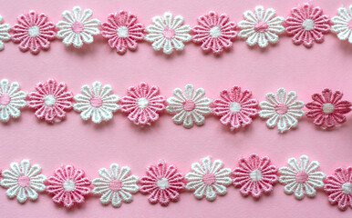 Background for needlework and sewing master, ribbons of flowers embroidered with threads., DIY. Blur effect. Weak focus. Embroidery by hand and machine.