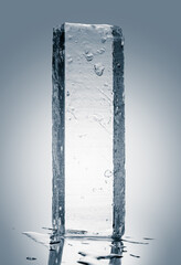 A rectangular block of clear natural ice, isolated on white background. Cold purity concept.