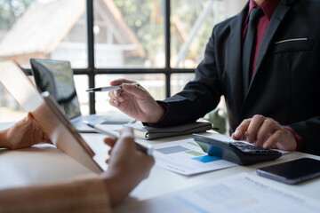 business team meeting Discuss strategy planning and calculating revenue performance with a new project plan. Financial and economic graphs with successful teamwork.