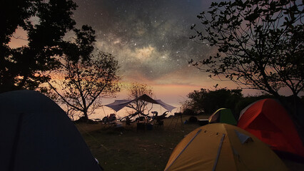 Hiking tent camping  on sea beach with light sky and galaxy milky way night scene on sky of Thailand, Long exposure photograph, with grain noise.