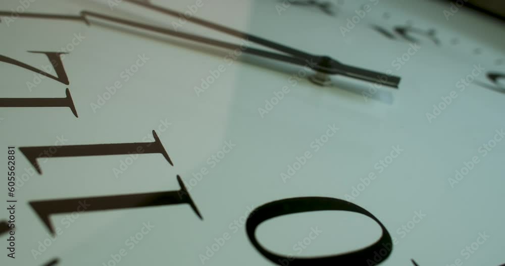 Aufkleber on the clock, we see a round dial with numerical markings or hour indicators, and two hands - the ho