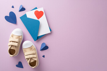 Affectionate son surprises his dad on Father's Day. Top-down view perspective of baby son's sneakers, heart-shaped props, envelope, postcard, on a lilac background with space for text or advertising