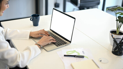 A female office worker using her laptop computer at her desk. laptop mockup