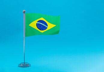 Brazilian table flag waving on blue background