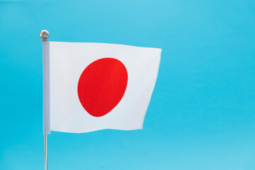 Japanese flag waving on blue background